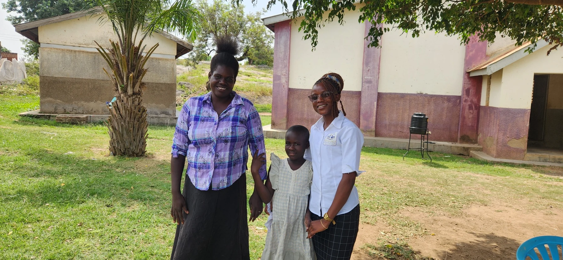 A community visit with a caregiver and child during field engagement.