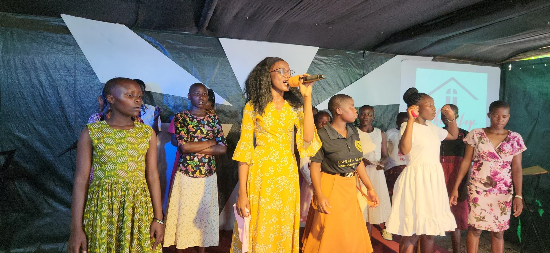 A lively programme moment with children and young people on stage.